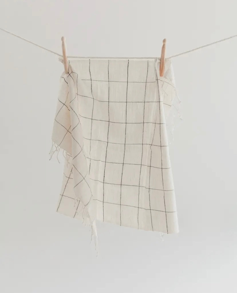 White towel with dark blue stripes in a windowpane pattern = handmade in Ethiopia.