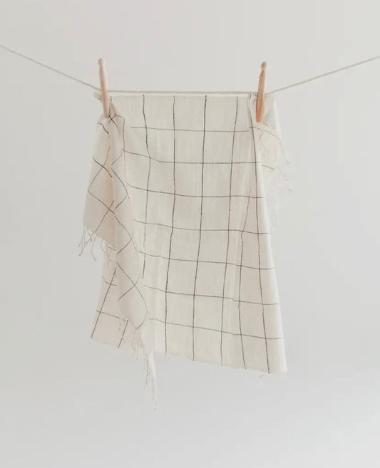 White towel with dark blue stripes in a windowpane pattern = handmade in Ethiopia.