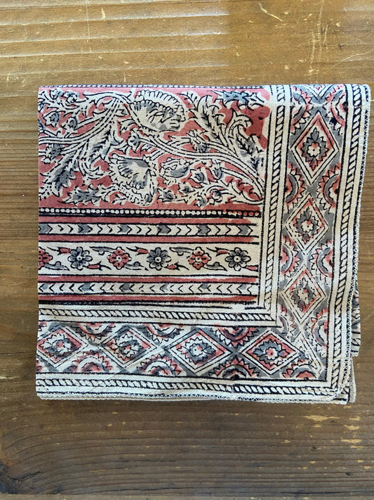 Decorative bandana with intricate patterns on a wooden surface