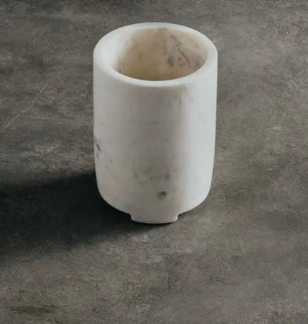 White marble wine chiller on a gray concrete surface