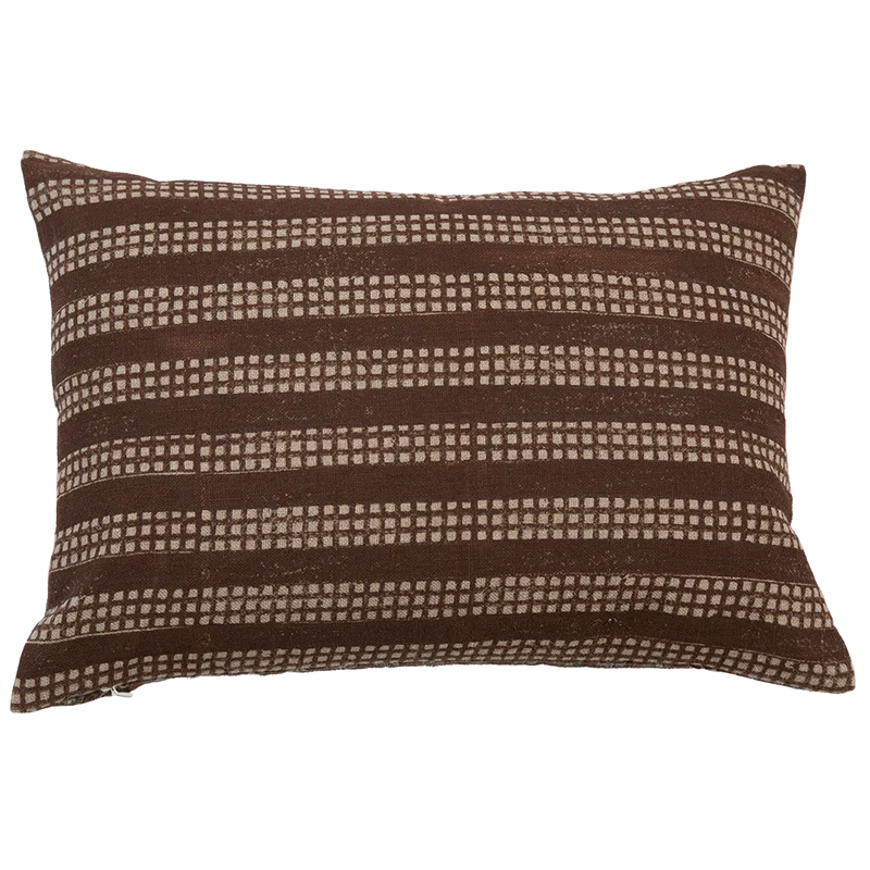 A square-shaped throw pillow with a brown and white geometric pattern by Filling Spaces