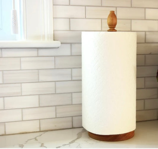 Oak paper towel holder with roll on kitchen counter.