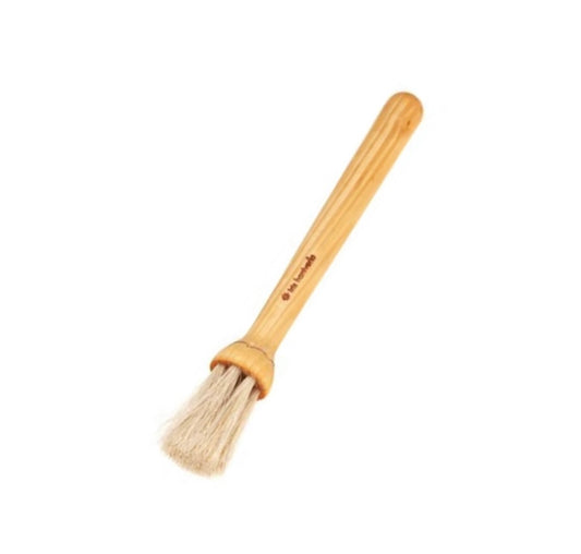 A beige pastry brush from Sweden with a rounded brush head and an oiled birch handle.