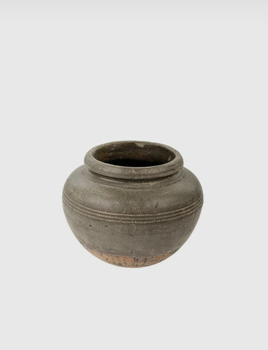 A gray Odessa Vase with a solid pattern and textured surface, designed for use as a decorative table piece.