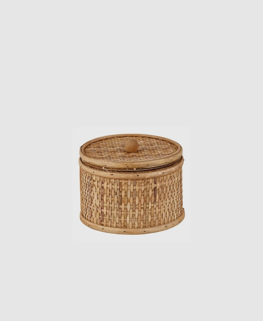 A woven rattan basket with a lid, primarily brown in color, against a white background.