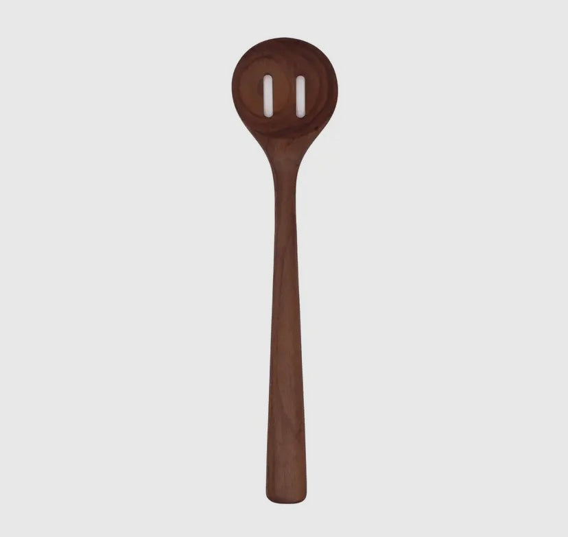 A handmade walnut wooden slotted spoon with a smooth finish.
