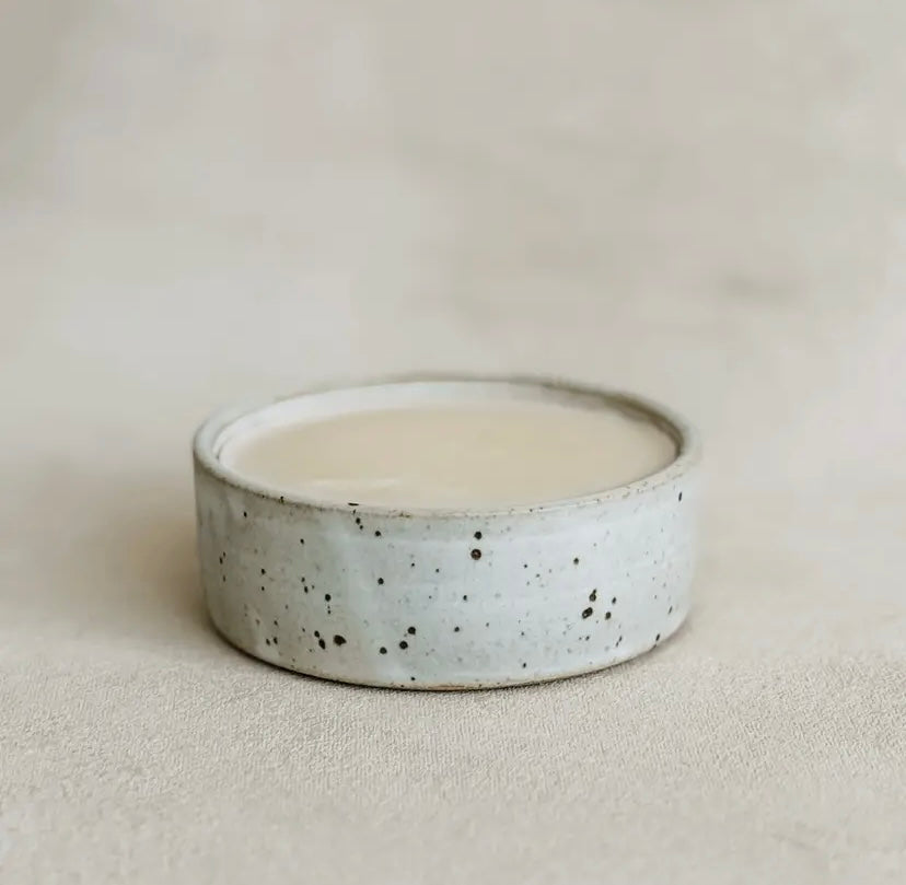 Speckled ceramic bowl filled with solid dish soap.