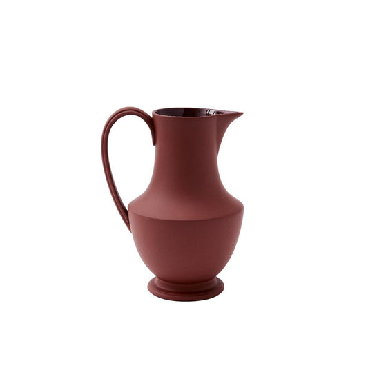 A medium-sized terracotta pitcher with a handle on the left side, displayed against a plain background.