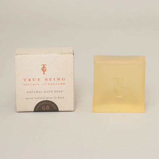 A bar of soap next to its packaging box, which has 'True Being' and 'Natural Bath Soap' text.