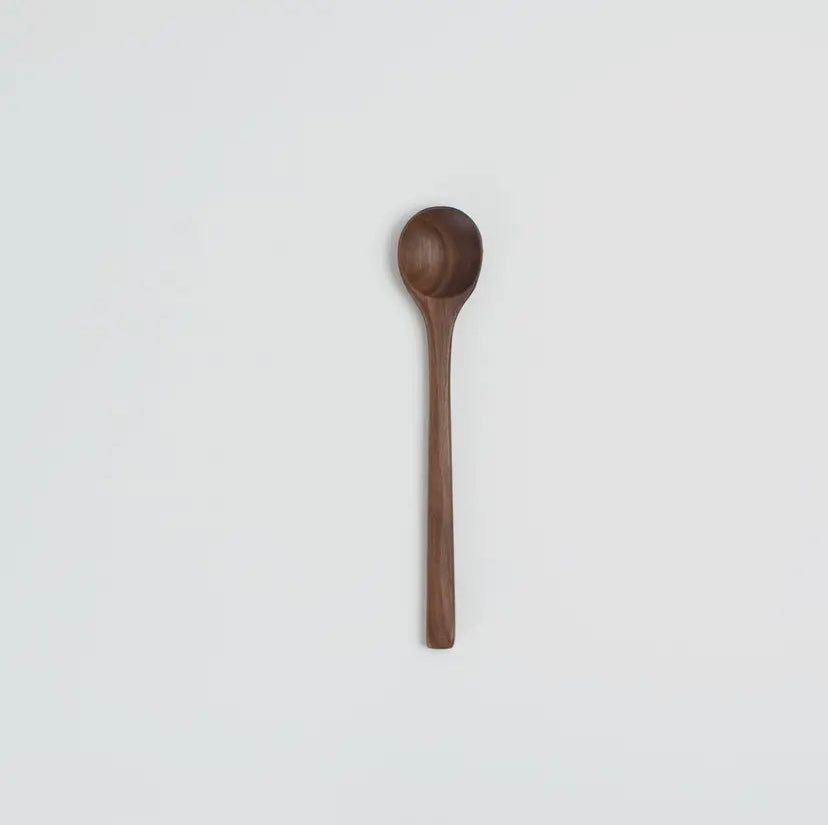 Wooden spoon on a light gray background