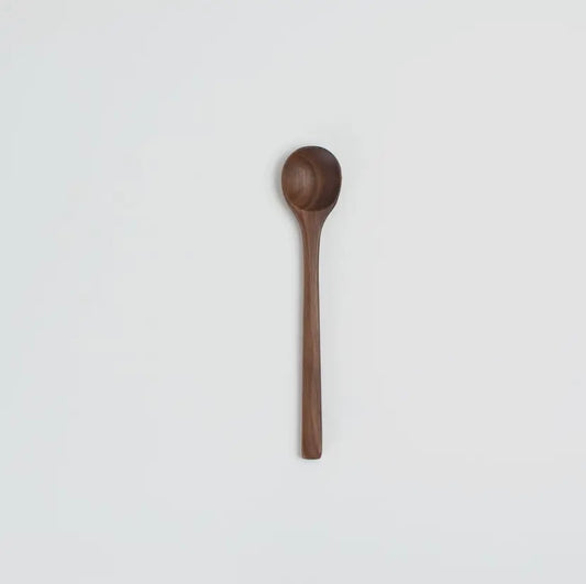 Wooden spoon on a light gray background