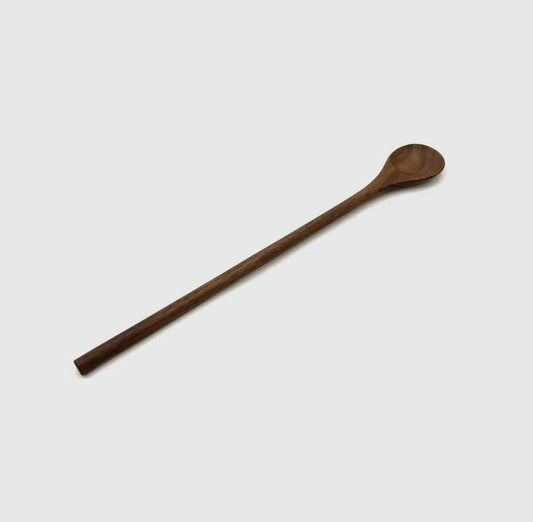 Close up of walnut stirring spoon.