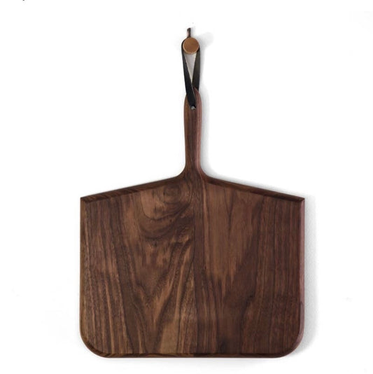 A large, walnut wood cutting board with a handle, designed in a whale bone shape, displayed against a white background.