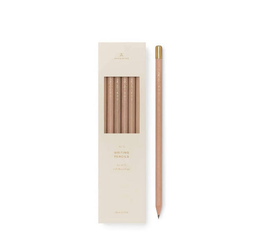 A set of gold-capped pencils with natural finish, displayed in an elegant box with a minimalist design.