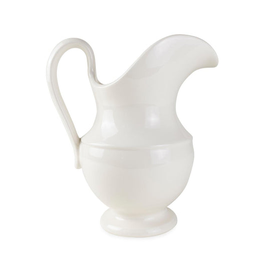 A white ceramic pitcher with a glossy interior and matte exterior finish, with a handle on the side and a spout for pouring.