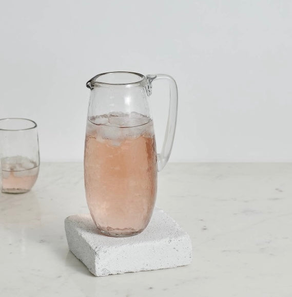 48 oz artisan glass pitcher filled with citrus water or cocktails.